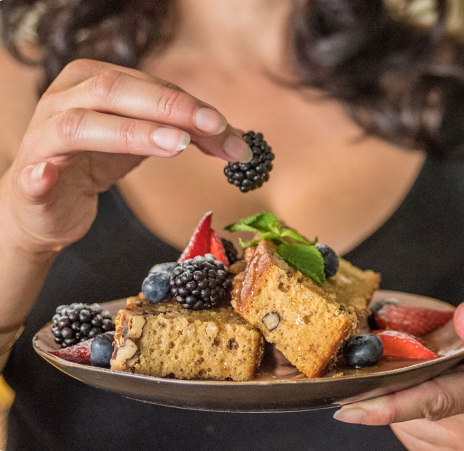 woman-placing-a-berry-on-a-cake